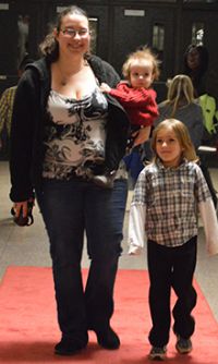 Kristin Jacob and son, kindergartner Josiah, walk the red carpet to applause