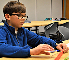 Nigel Doyle, of Grand Rapids, diligently tries to figure out the balance problem