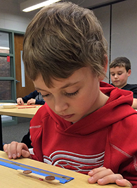 Nicholas Burkel, of Forest HIlls, works on the classroom activity