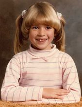 Emily McAlpine’s second-grade school photograph at age 8