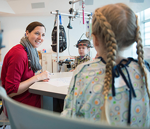 Sarah Smith works with Dana (in pigtails) and Jacob on “Niceness Ninjas” in Club TCB (photo courtesy Helen DeVos Children’s Hospital) 