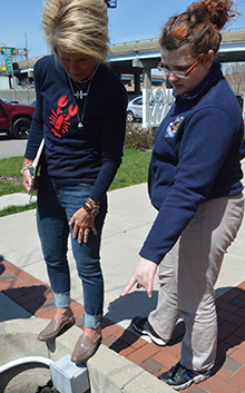 UPrep teacher Sherri Kraai talks about how a bioswale works with seventh-grader Journey Berkenpas