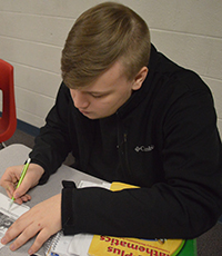 Sophomore Noah Tracey makes notes in the margin during his close read on trigonometry 