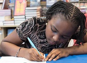 Oummu S. Kabba signs her books, which she began publishing at age 8