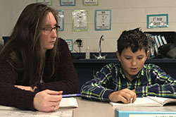 Paraprofessional Lisa Batchelor works on reading with sixth-grader Austin Stauffer