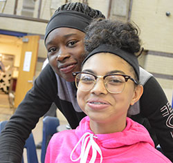 Cydney Hansma and her friend, Marquaisa Welch, eat lunch at Kelloggsville Middle School