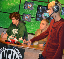 Anchors Brett Van Wagoner and Linnea Eastburg prepare to go live while Shane Sebuck checks their microphones