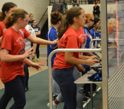 Girls compete, commanding their robots to move