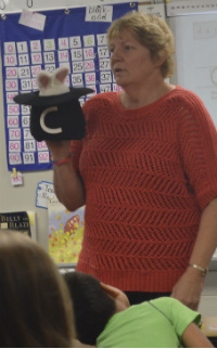 Teacher Mary Lou Ohnsman gets help from the “Magic C Bunny” in teaching her third-graders handwriting 