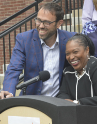 Superintendent Teresa Weatherall Neal and school board President Tony Baker enjoy a moment at the press conference 