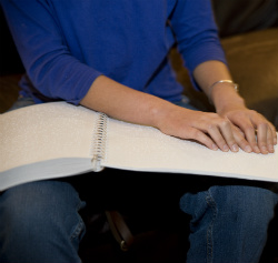 Julia reading braille on paper