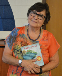 F. Isabel Campoy holds a copy of her new book, “Maybe Something Beautiful” at Westwood Middle School