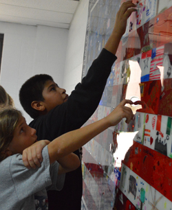 Godfrey-Lee students find their tiles in the assemblage of pieces