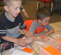 Kindergartners break into groups for math exercises in teacher Andrew Smith’s Brown Elementary School classroom 