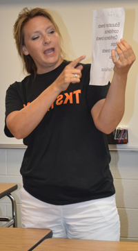 Teacher Molly Stabler shows students a Confucius quote