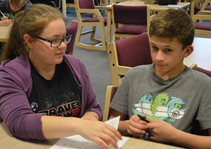 Junior Emily Sternburgh lends a hand to a Mill Creek Middle School student