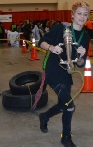 A City High School student takes a first responder challenge to drag a tire through an obstacle course