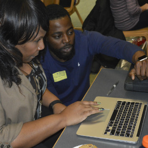 Stasha Gilbert gets tips on using her MacBook Air from Apple technician Segun Oyesile