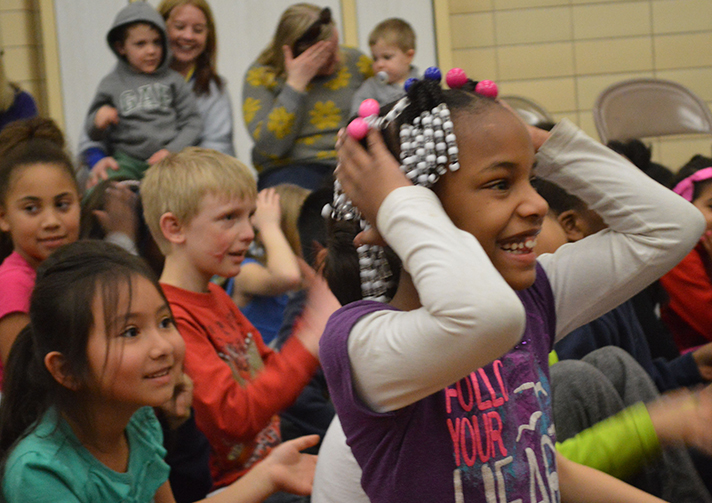 Second-grader Sparkle Murray, and her classmates react to the performanc