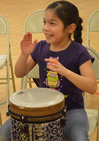 Isabel Deleon-Magana smiles as she plays