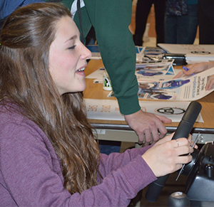 Freshman Cassie Stersic tests her driving skills on the distracted-driving simulator