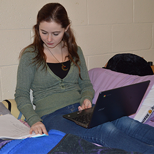 Jordan Lovett studies in her dorm room