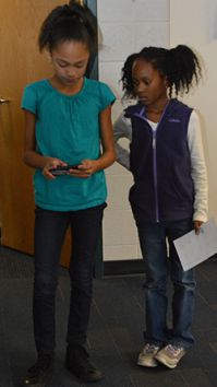 Endeavor Elementary fifth-grader Jaidah Williamson teaches second-grader Kendall Sallie how to program Sphero, a robotic ball