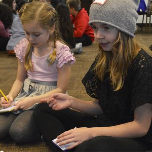 Lydia DeWitt makes a point about the book “Echo” while Aurora Thompson takes notes