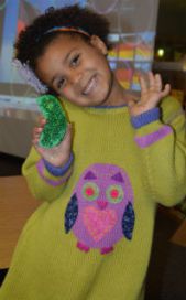 Anaya Jacobs shows off her handmade German pickle ornament