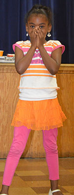 West Kelloggsville Elementary second-grader Omariyah Wilson-Smith reacts to magician Tom Plunkard’s tricks