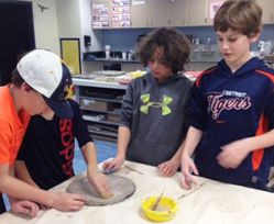 Students create clay sculptures for the mural