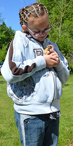 Fourth-grader Jakquelynne Ridout pets a duckling