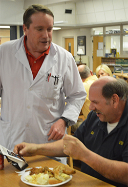 Chemistry teacher Bill Larson chats with Eddie Michalec at the retirement party