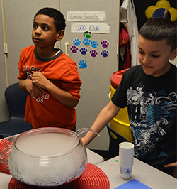 Students Javari Rodriguez and Dominic Diaz serve Wolf Juice