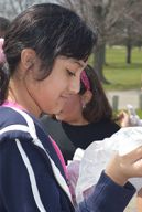 Parkview Elementary School fourth-grader passes out trash bags before beginning a cleanup of Lamar Park