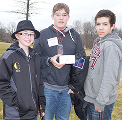 Eighth-graders David Marsh, Nathan Lemons and Chandon Reed get in some geocaching during the Kent ISD-sponsored alternative spring break