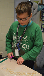 Zachary Trepins works on his group’s bridge