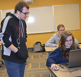 Junior and club co-founder Connor Young looks on as junior Alyssa Yost plays