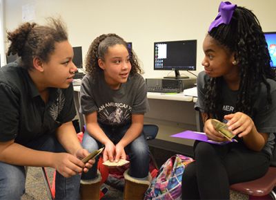 Seventh-graders Tajanna Price, Morgan Lamar and Shia Jenkins chat