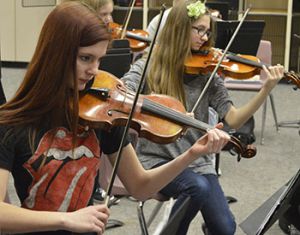 Corrina Wenger (left) and Chloe Looman hone their violin parts 