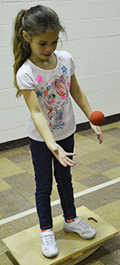 First grader Aleah Nesbitt tosses the ball