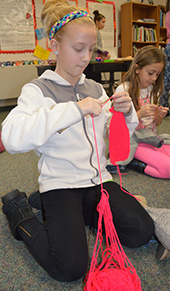 Fourth-grade Breton Downs Elementary student Avery Van Hekken knits