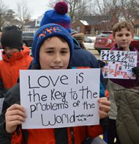 Fourth-grade student Jake Castenholz holds a sign during the march