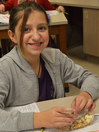 Sixth-grade student Layna Richards-Raymond eats popcorn trail mix