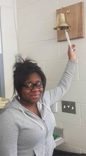 Recent Frontiers Program Graduate Lillian James rings the bell celebrating her early high school graduation