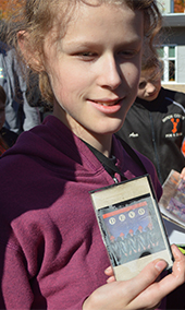 Nickels Intermediate School sixth-grader Brenna Stachnic holds a DEVO tape from the capsule