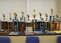 “We the People” trophies line the wall in Janice Yates’ classroom