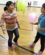 Migrant student Romalda Ordaz plays with a friend during gym class