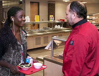 Chef Mo talks with student during breakfast