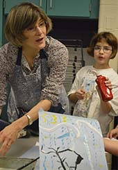 Deb Trent instructs students to clean up while Paige Campbell looks on